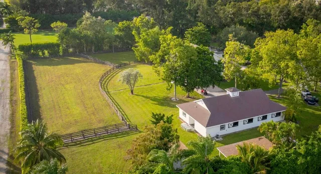 an aerial view of a residential houses with outdoor space and street view