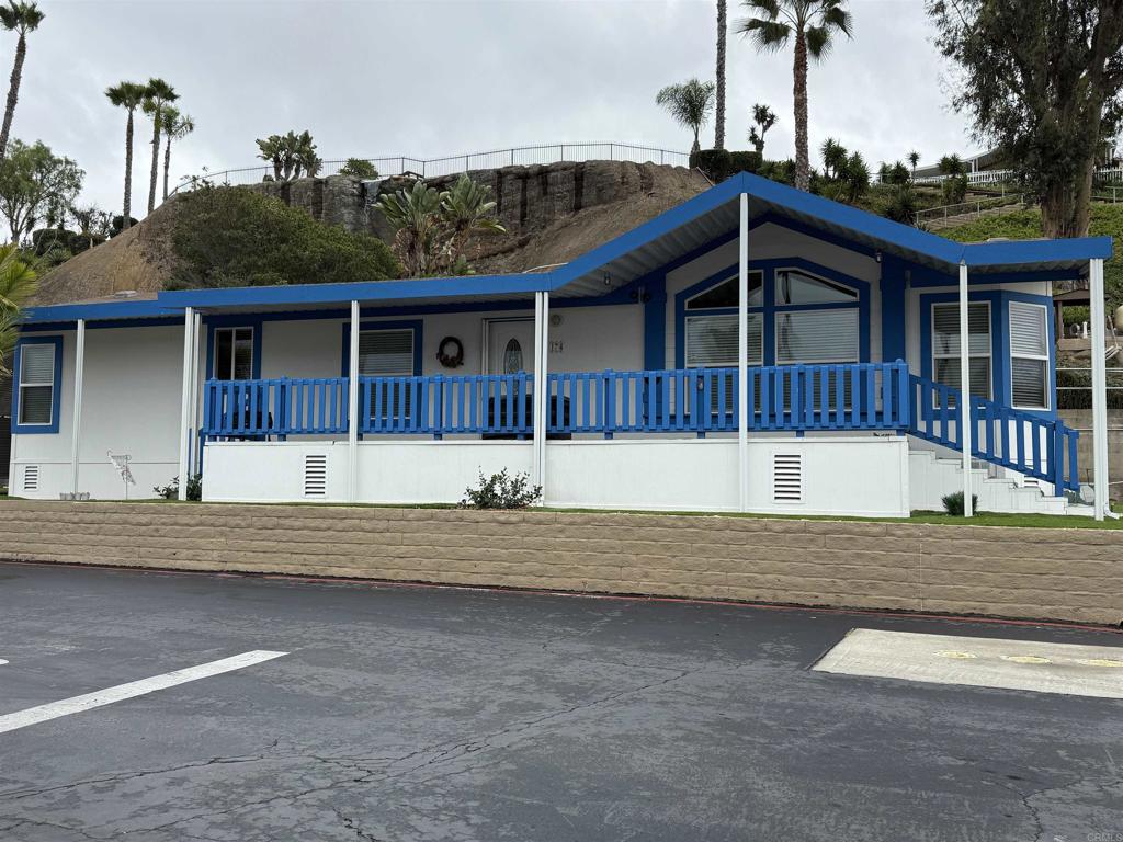 a view of house with a yard and a wooden fence