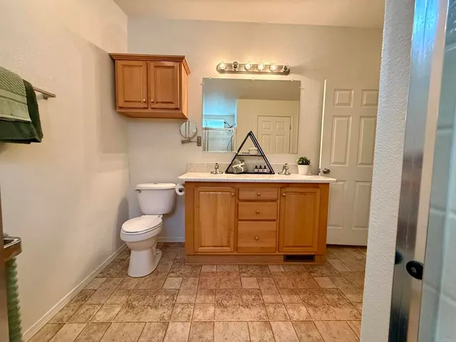 a bathroom with a toilet sink and mirror