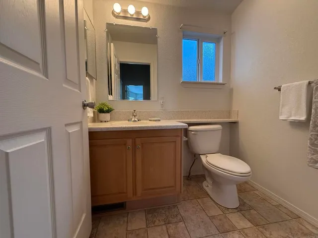 a bathroom with a sink toilet and mirror