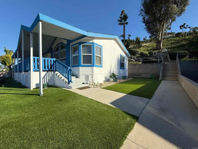 an aerial view of residential houses with outdoor space and parking