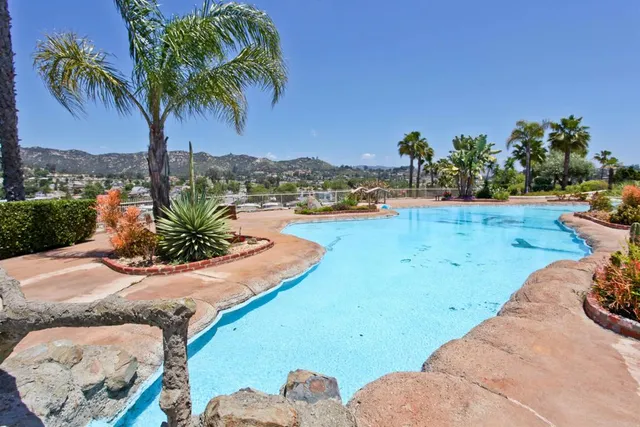 a view of a swimming pool with a yard