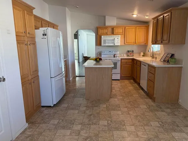 a kitchen with stainless steel appliances a refrigerator and a sink