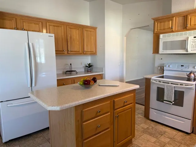 a kitchen with a stove cabinets and refrigerator