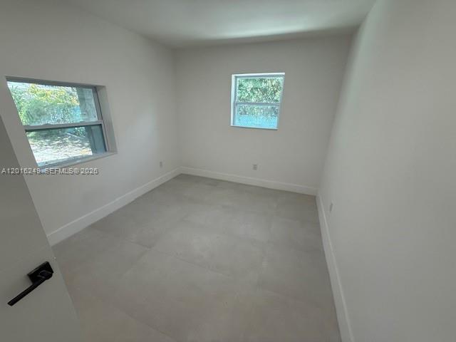 328 Northeast 57th Street Miami, FL 33137 - Photo 14 of 16 an empty room with a window