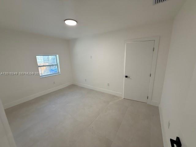 328 Northeast 57th Street Miami, FL 33137 - Photo 10 of 16 a view of an empty room with a window