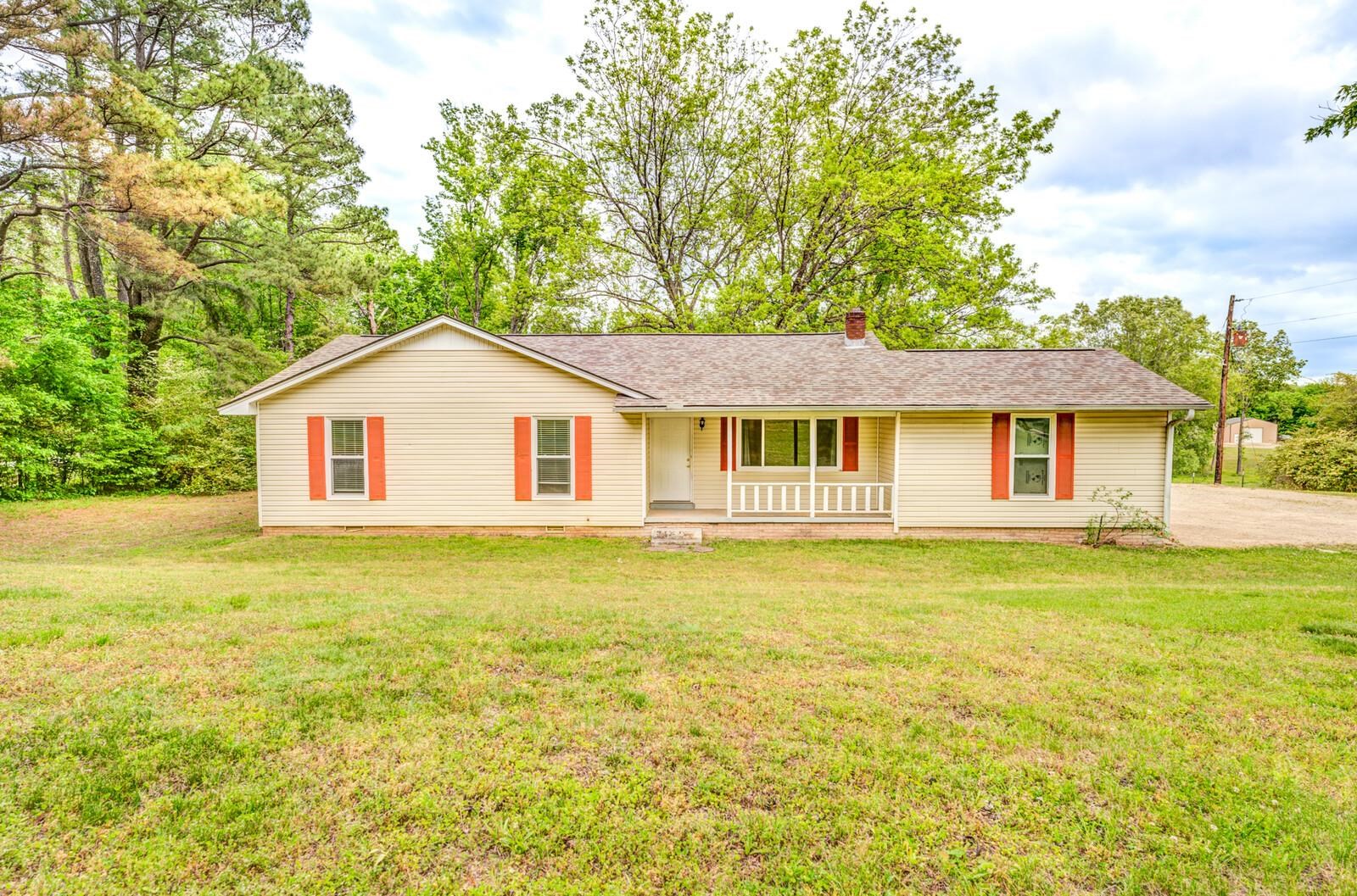 6125 Warren Road Oakland, TN 38060 - Photo 1 of 40 Single-story residence featuring light-colored siding, a covered front porch with white railing, and contrasting red shutters