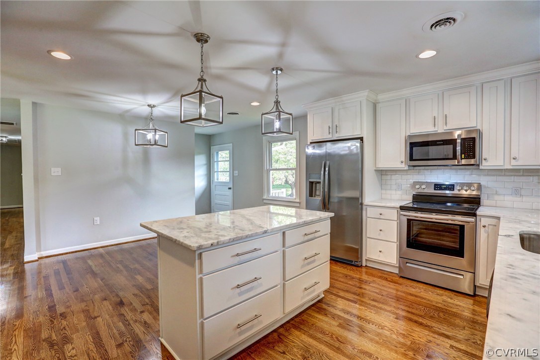 1820 Hawk Town Road Maidens, VA 23102 - Photo 22 of 46 a kitchen with kitchen island granite countertop stainless steel appliances and wooden cabinets