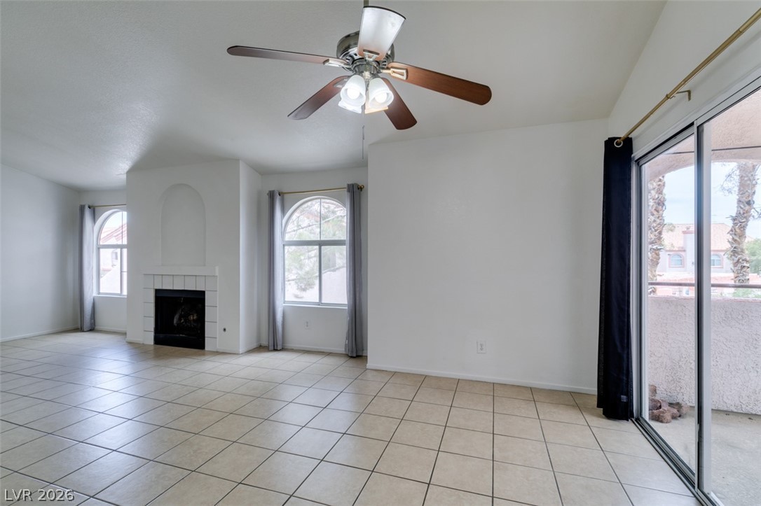 7570 West Flamingo Road, Unit 252 Las Vegas, NV 89147 - Photo 15 of 44 A well-lit living area showcases a corner fireplace and ample space for relaxation.