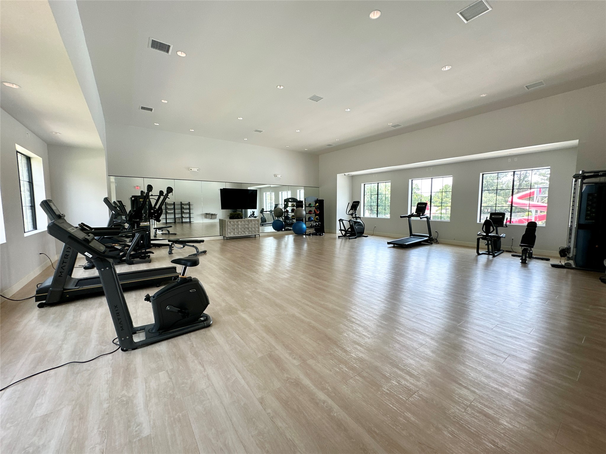 12198 Ridge Top Drive Conroe, TX 77304 - Photo 22 of 27 a view of a room with gym equipment and wooden floor