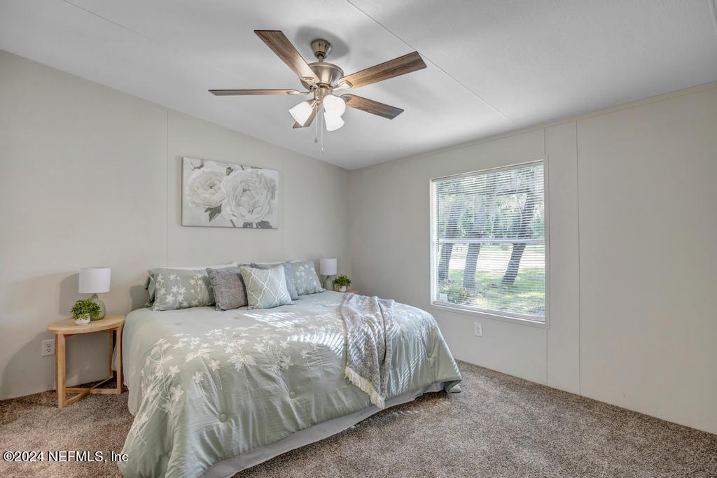 5557 Acadia Street Keystone Heights, FL 32656 - Photo 17 of 32 a bed room with a bed and a window