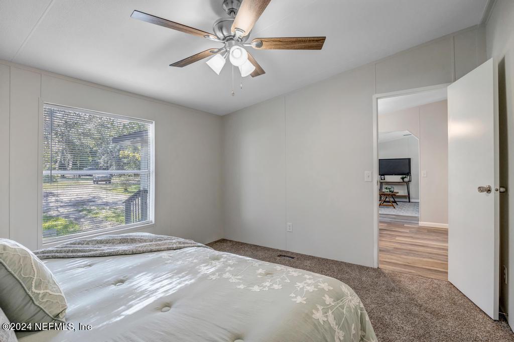 5557 Acadia Street Keystone Heights, FL 32656 - Photo 19 of 32 a bedroom with a large bed and a window