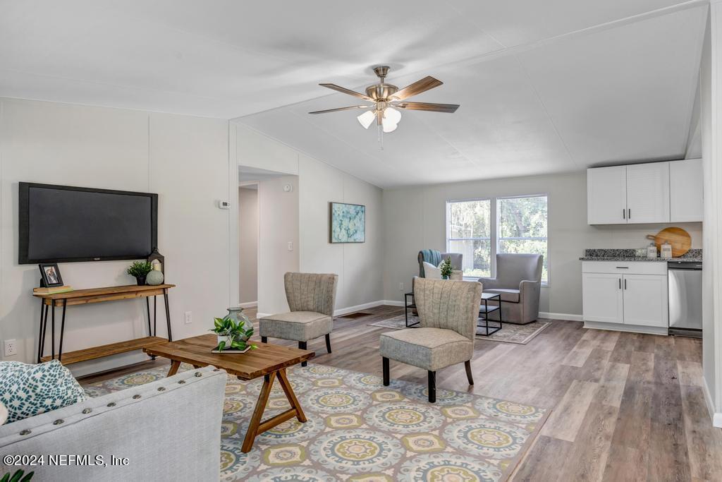 5557 Acadia Street Keystone Heights, FL 32656 - Photo 2 of 32 a living room with furniture and a flat screen tv