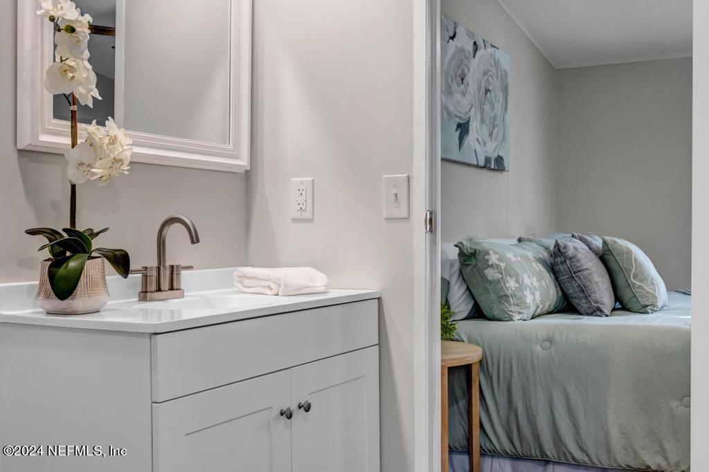 5557 Acadia Street Keystone Heights, FL 32656 - Photo 22 of 32 a bathroom with a sink and a mirror