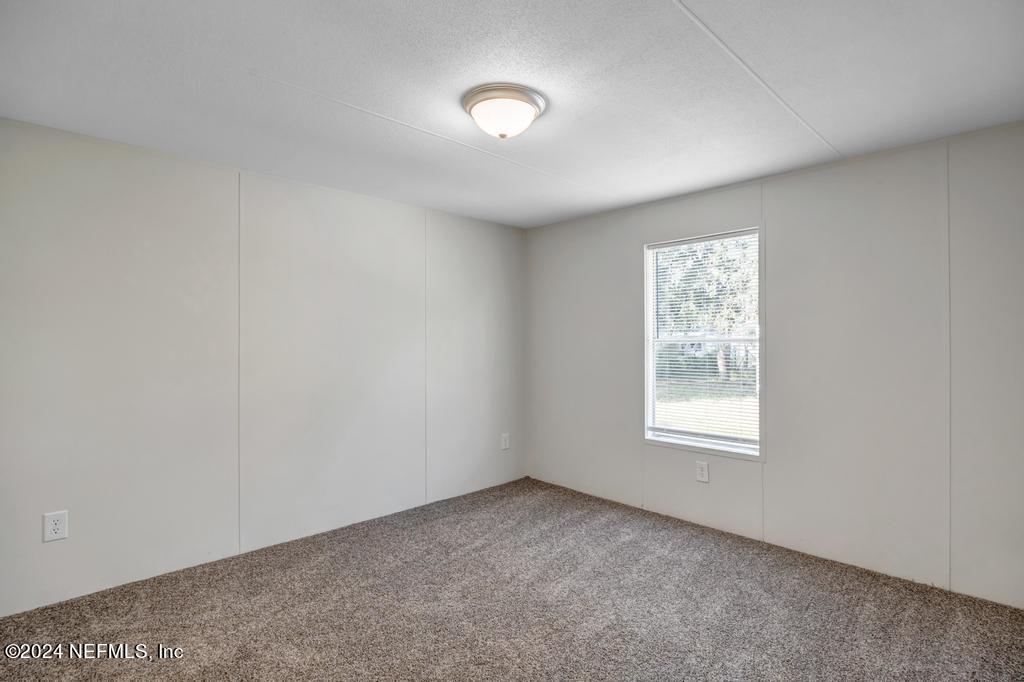 5557 Acadia Street Keystone Heights, FL 32656 - Photo 23 of 32 an empty room with a window