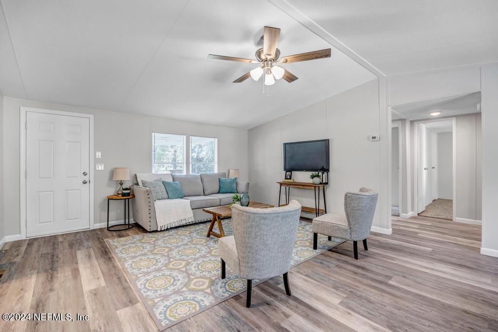 5557 Acadia Street Keystone Heights, FL 32656 - Photo 7 of 32 a living room with furniture and a flat screen tv