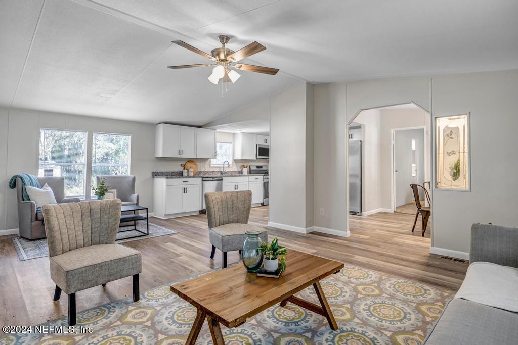 5557 Acadia Street Keystone Heights, FL 32656 - Photo 9 of 32 a living room with furniture and kitchen view