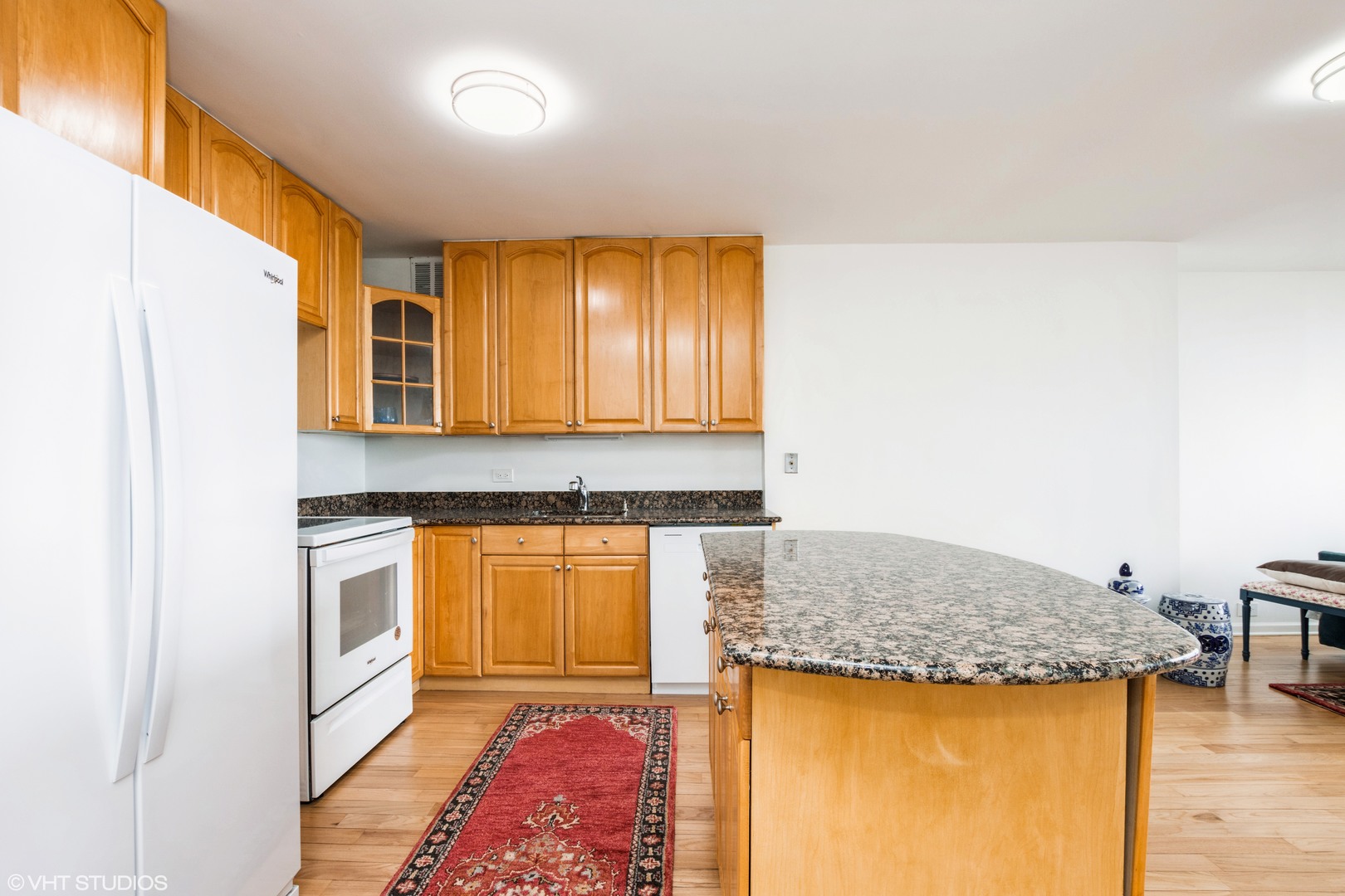 5415 North Sheridan Road, Unit 1504 Chicago, IL 60640 - Photo 6 of 21 a kitchen with stainless steel appliances granite countertop a sink and a refrigerator
