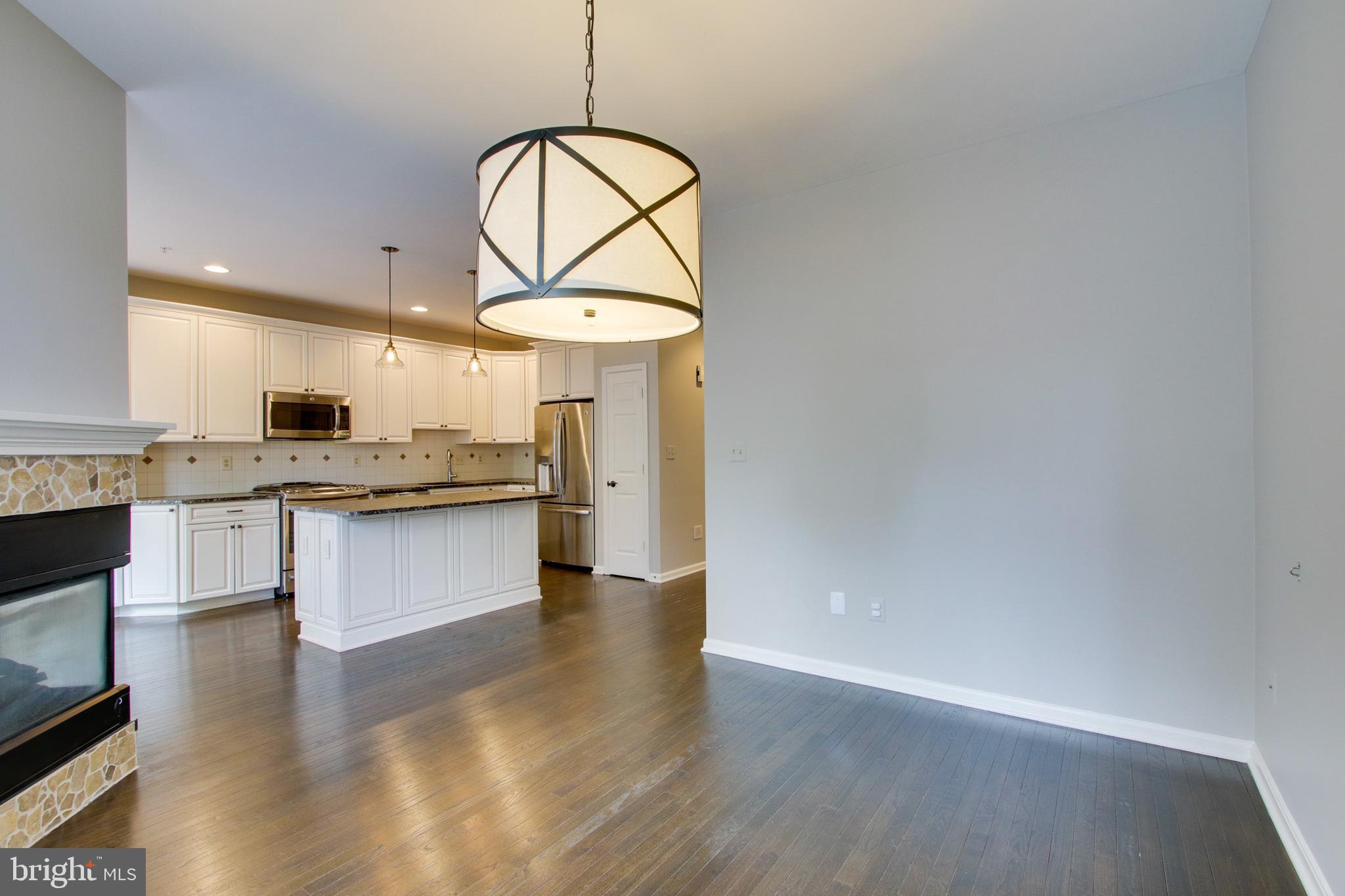 8818 Howard Forest Lane Baltimore, MD 21208 - Photo 14 of 31 a kitchen with stainless steel appliances granite countertop a stove a sink and a wooden floors