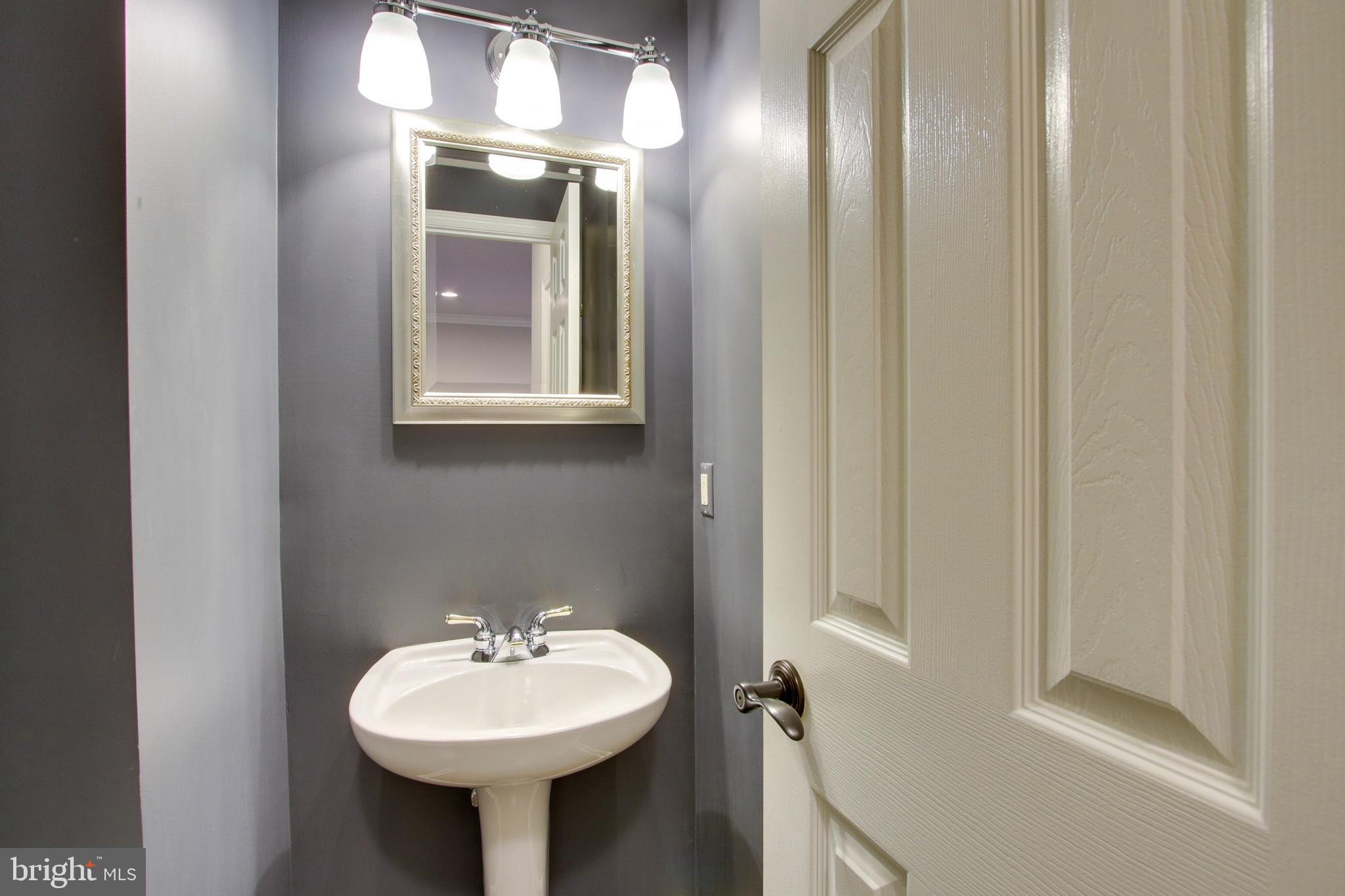 8818 Howard Forest Lane Baltimore, MD 21208 - Photo 15 of 31 a bathroom with a sink and a mirror