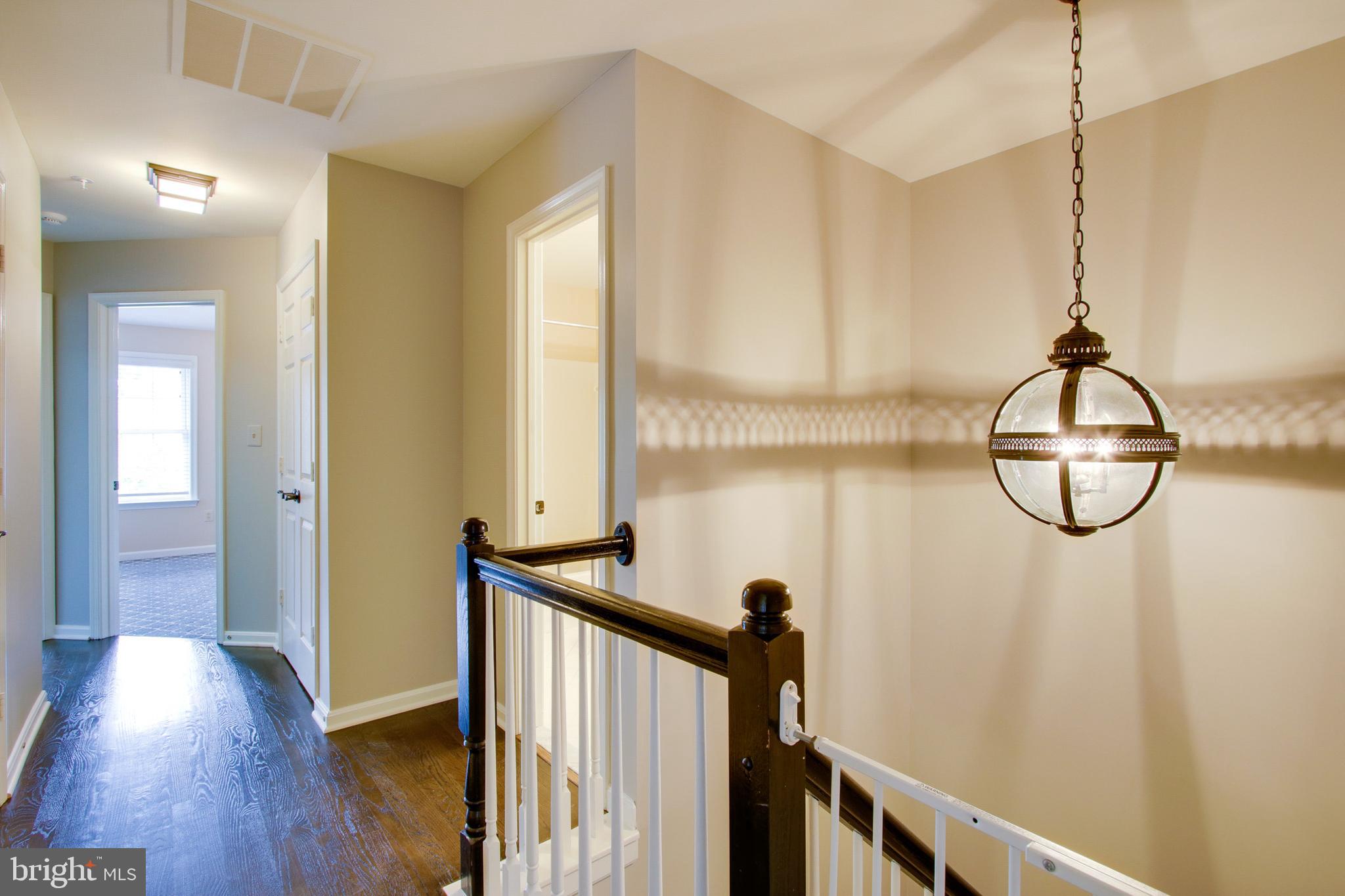 8818 Howard Forest Lane Baltimore, MD 21208 - Photo 16 of 31 a view of a room with wooden floor and windows