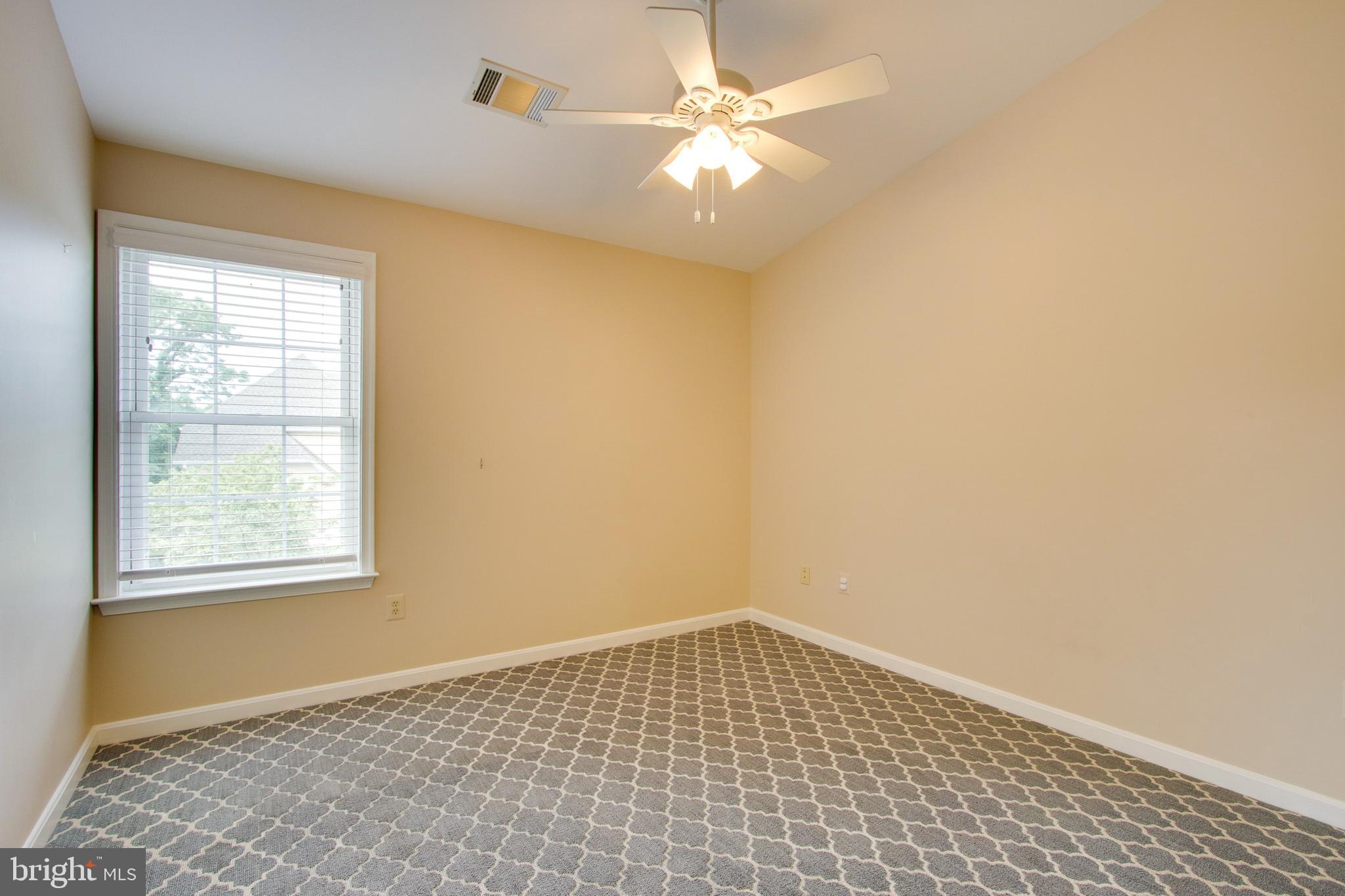 8818 Howard Forest Lane Baltimore, MD 21208 - Photo 23 of 31 an empty room with windows