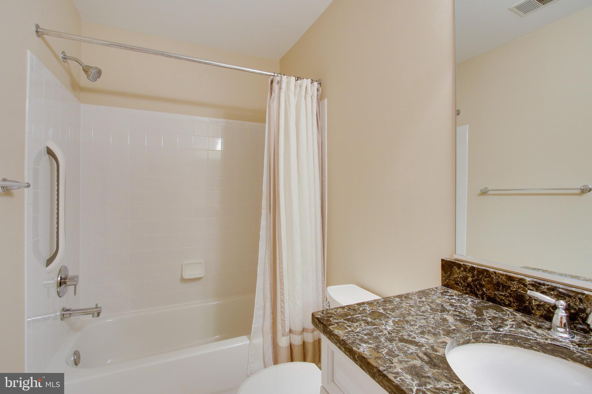8818 Howard Forest Lane Baltimore, MD 21208 - Photo 27 of 31 a bathroom with a granite countertop sink toilet and shower