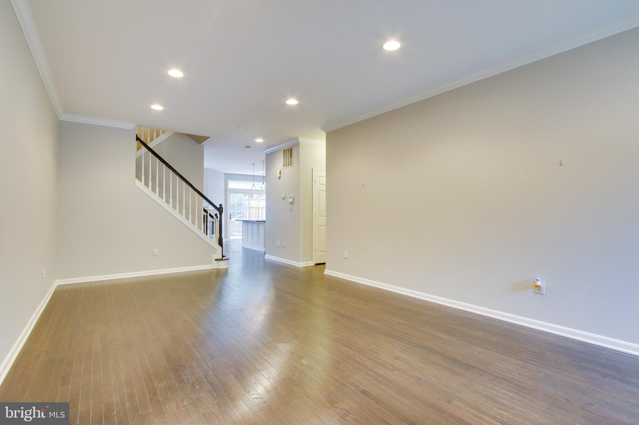 8818 Howard Forest Lane Baltimore, MD 21208 - Photo 4 of 31 a view of a hallway with wooden floor