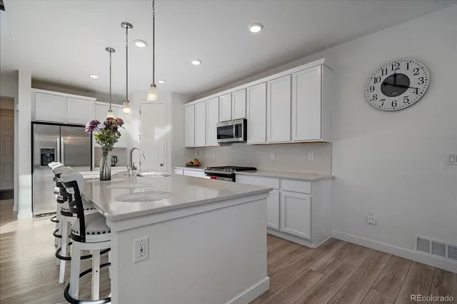 a kitchen with a sink appliances and cabinets