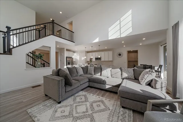 a living room with furniture or couch and a chandelier