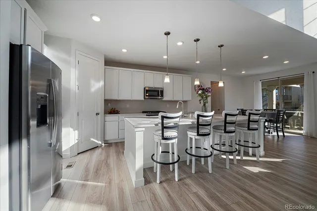 a large kitchen with a table and chairs