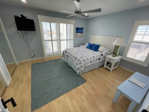 a bedroom with a large bed and a window