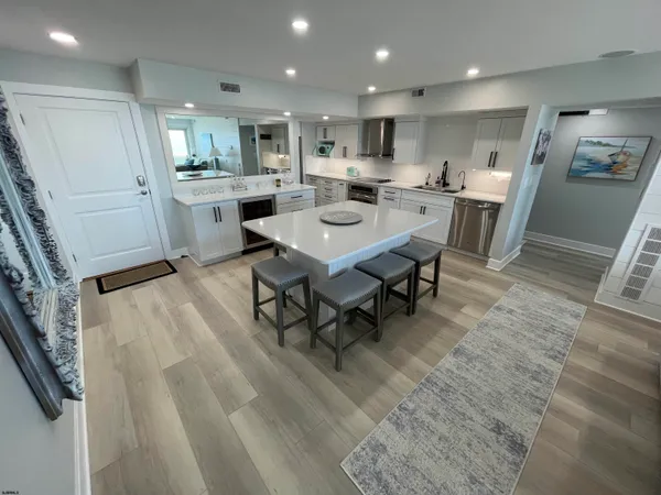 a kitchen with a dining table chairs appliances and cabinets