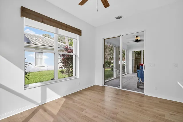 a view of an entryway with wooden floor and windows