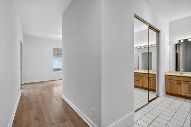 a view of hallway with cabinets and wooden floor