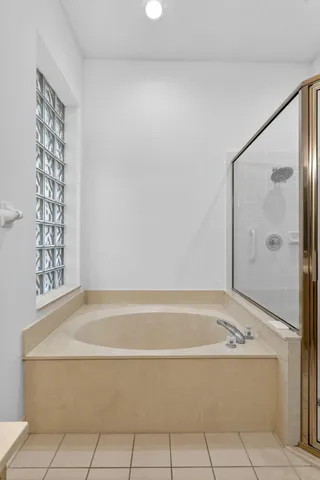 a bathroom with a bathtub and shower