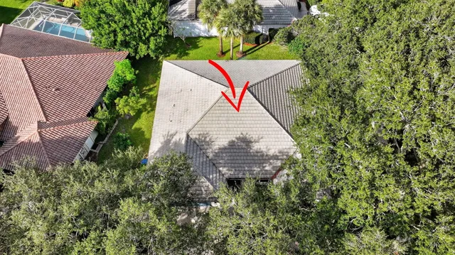 an aerial view of a house with a yard and garden