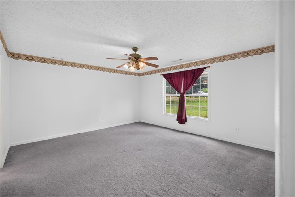 602 Pendergrass Road Winder, GA 30680 - Photo 20 of 44 a view of a room with window and chandelier fan