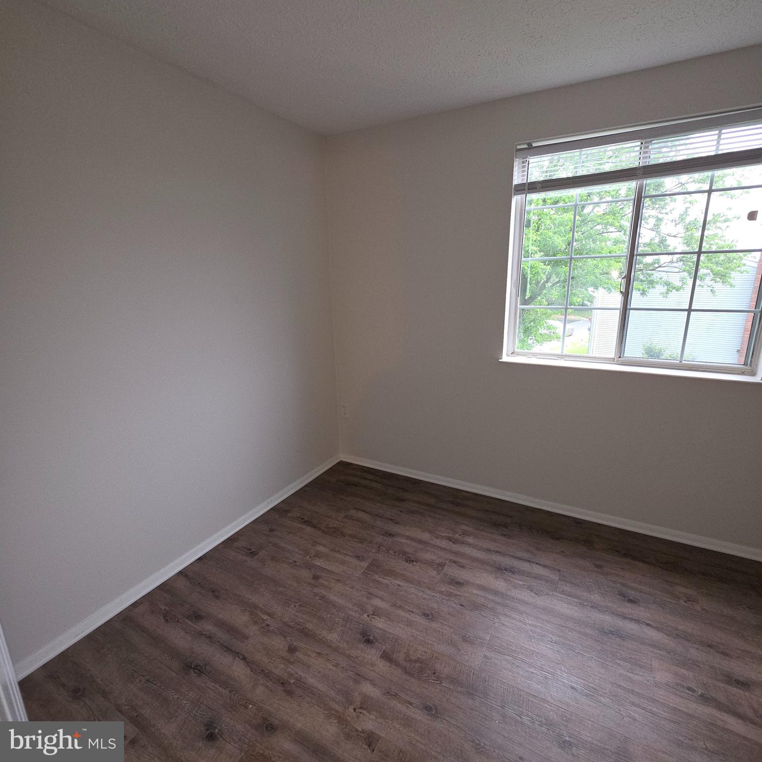 1758 Springfield Lane Frederick, MD 21702 - Photo 22 of 31 a view of an empty room with wooden floor and a window