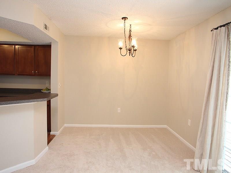 7737 Falcon Rest Circle, Unit 7737 Raleigh, NC 27615 - Photo 4 of 18 With breakfast bar. Overlooks private deck and backyard area.