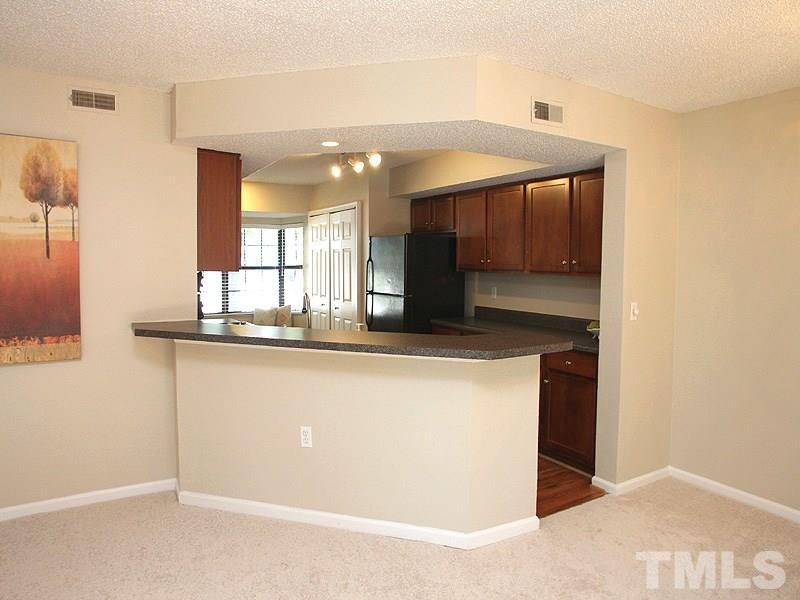 7737 Falcon Rest Circle, Unit 7737 Raleigh, NC 27615 - Photo 18 of 18 Perfect for bar stools. Open floorplan for easy entertaining.
