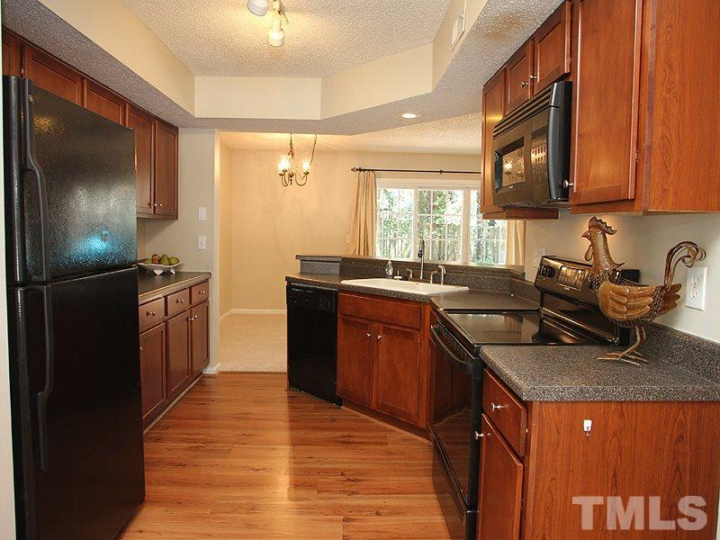 7737 Falcon Rest Circle, Unit 7737 Raleigh, NC 27615 - Photo 5 of 18 Updated cabinets, countertops and laminate flooring. Smooth top range.