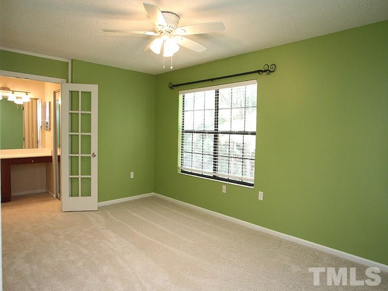 7737 Falcon Rest Circle, Unit 7737 Raleigh, NC 27615 - Photo 7 of 18 Open and bright with neutral paint. French doors into the vanity and bath area. Large walk-in closet.