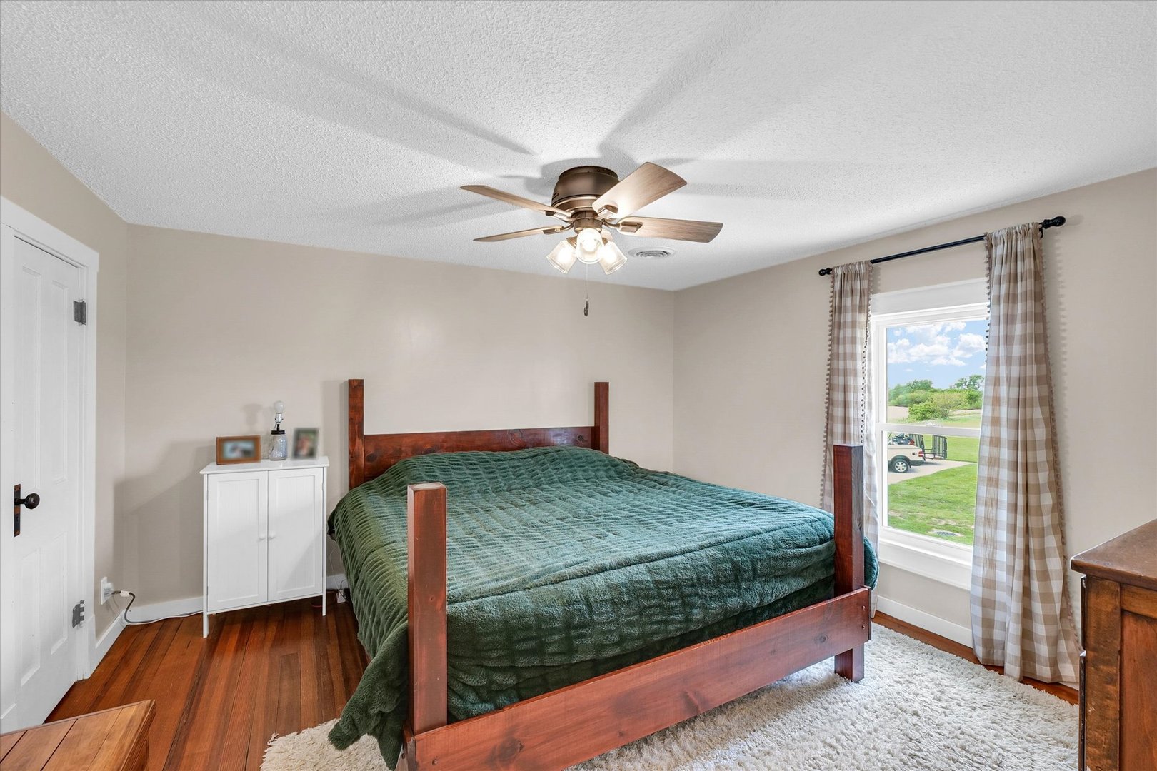 55 North 2600E Road Rankin, IL 60960 - Photo 26 of 48 a bedroom with a bed and a chandelier