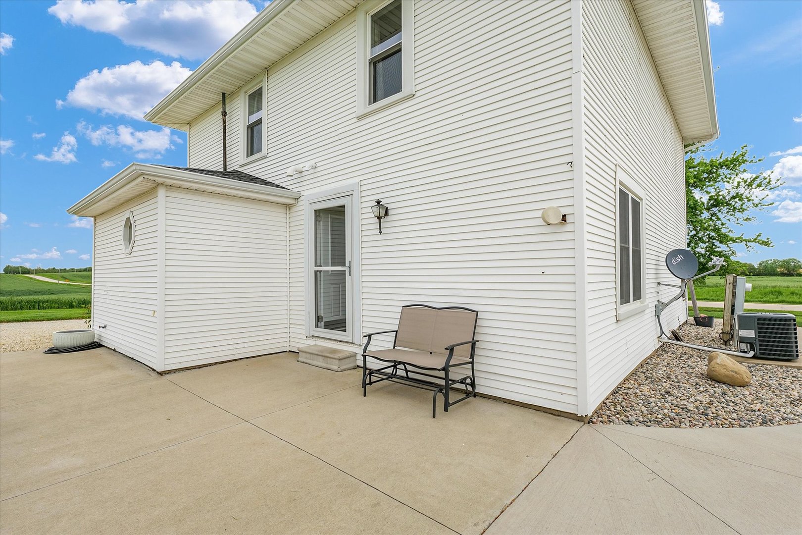 55 North 2600E Road Rankin, IL 60960 - Photo 43 of 48 a view of a white house with a chairs in patio