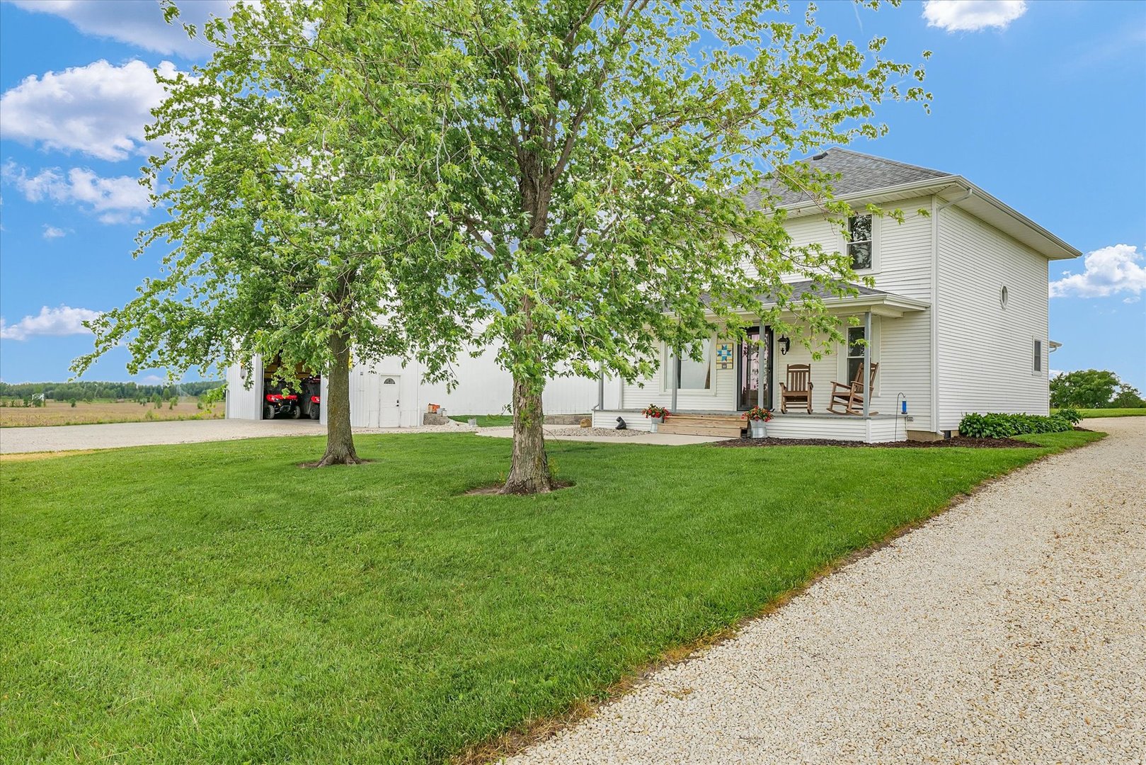 55 North 2600E Road Rankin, IL 60960 - Photo 5 of 48 a view of a white house with a big yard and large tree