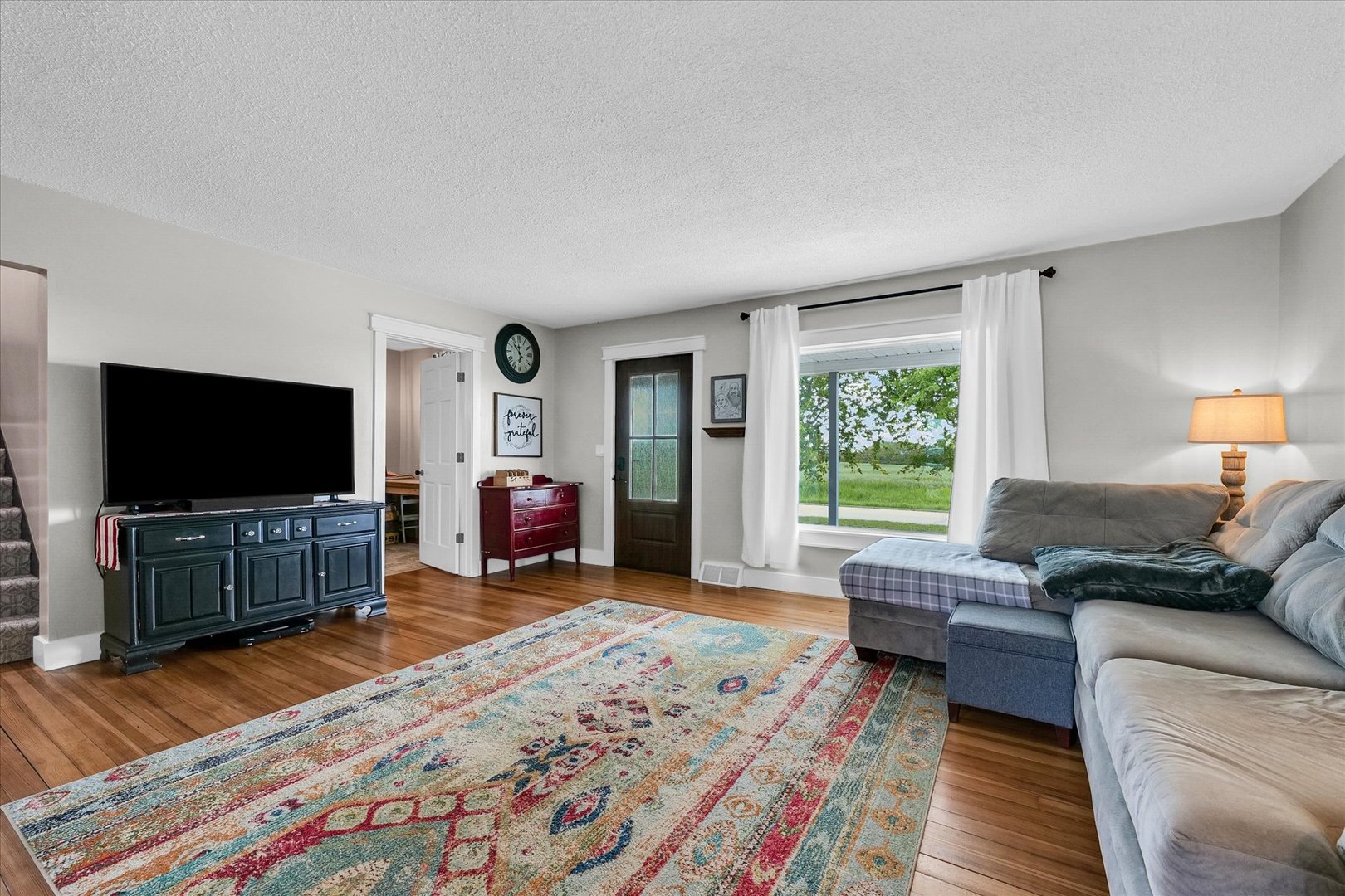 55 North 2600E Road Rankin, IL 60960 - Photo 9 of 48 a living room with furniture and a flat screen tv