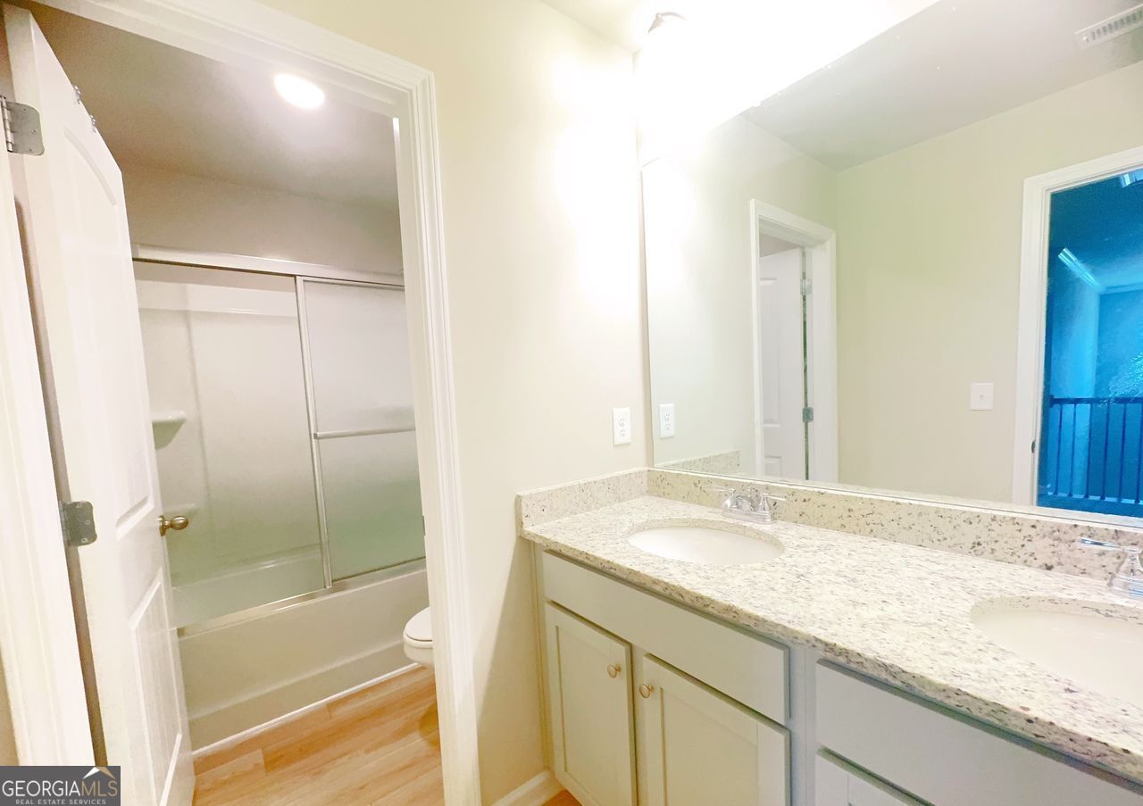 446 Sawmill Trace Hampton, GA 30228 - Photo 11 of 15 a bathroom with a granite countertop sink and a mirror