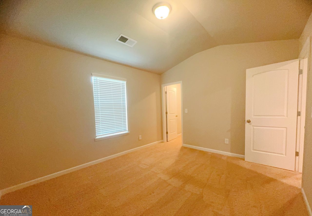 446 Sawmill Trace Hampton, GA 30228 - Photo 12 of 15 a view of an empty room with a window
