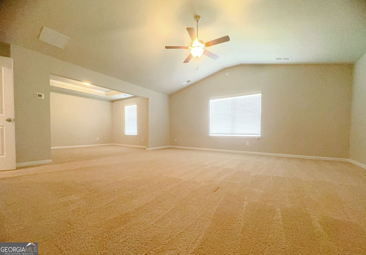 446 Sawmill Trace Hampton, GA 30228 - Photo 14 of 15 an empty room with a window and a ceiling fan